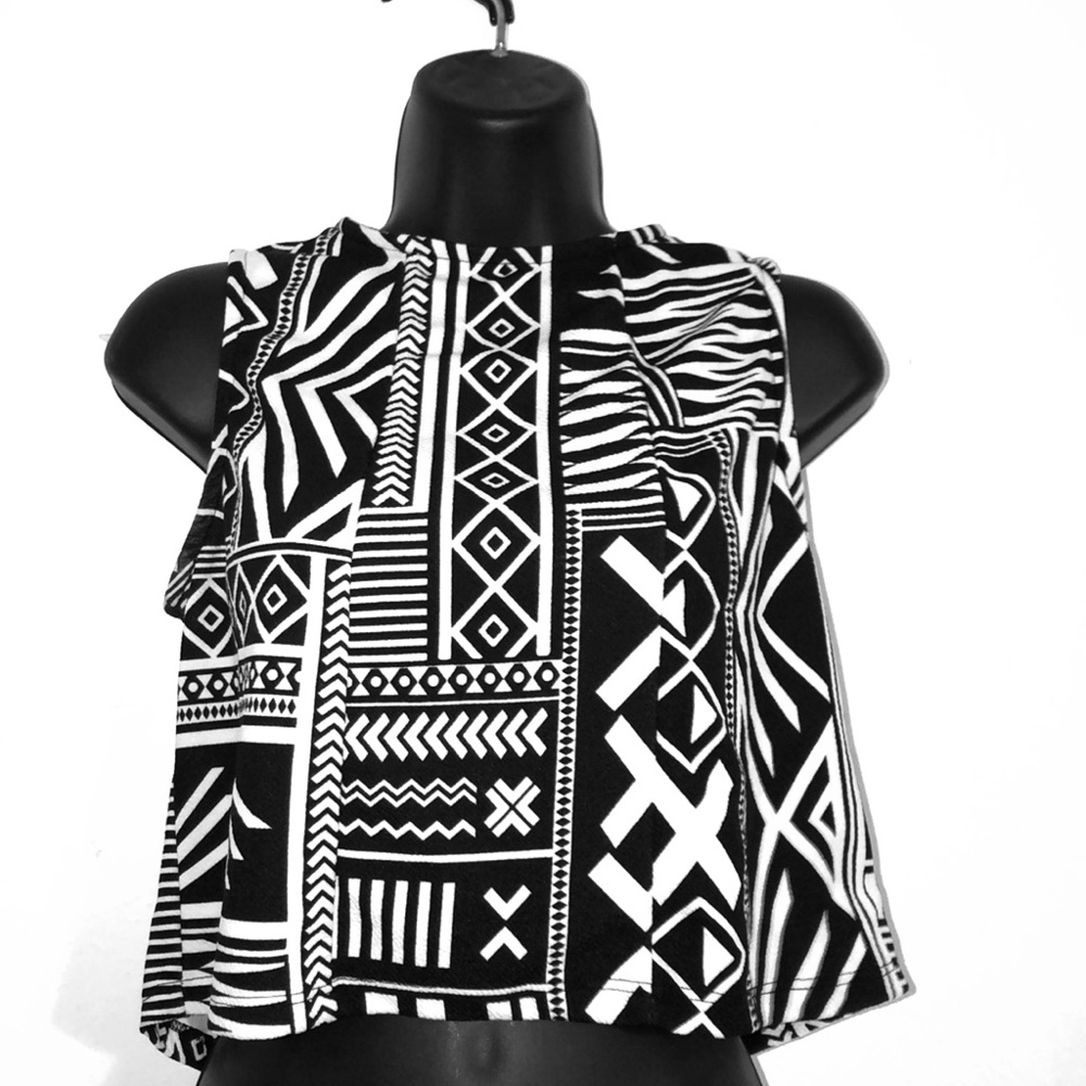 An accented black and white sleeveless blouse.